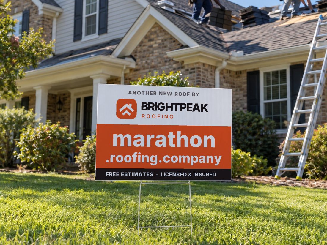 marathon.roofing.company on a yard sign in front of a house getting a new roof